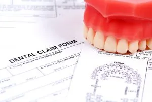 insurance papers and top teeth mold